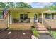 Charming front porch with American flag, rocking chairs, and manicured landscaping at 2095 Gherry Dr, Austell, GA 30106
