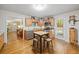 An open kitchen with stainless steel appliances, wood cabinets, a light wood kitchen island with metal stools, and an open entrance to the living room at 2095 Gherry Dr, Austell, GA 30106