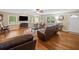 Bright living room with wood floors, large windows, fireplace and comfortable seating arrangements at 2095 Gherry Dr, Austell, GA 30106