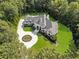 Breathtaking aerial view of a luxurious home featuring a circular driveway, lush landscaping, and a grand entrance at 330 Longvue Ct, Johns Creek, GA 30097