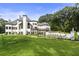Expansive backyard with pristine lawn, swimming pool, and elegant white home creates an inviting space at 330 Longvue Ct, Johns Creek, GA 30097