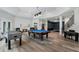 Finished basement featuring a game area, a fireplace, and stairs leading to another level at 330 Longvue Ct, Johns Creek, GA 30097