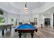 Finished basement featuring a game area, a fireplace, and doors leading to an outdoor area at 330 Longvue Ct, Johns Creek, GA 30097