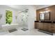 A bright bathroom featuring a soaking tub, shower, and wood vanity with contemporary finishes at 330 Longvue Ct, Johns Creek, GA 30097