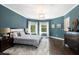 Bedroom with hardwood floors, bedside lamps, and large windows dressed with white curtains at 330 Longvue Ct, Johns Creek, GA 30097