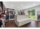 Large walk-in closet featuring wood floors, bench with storage, and custom shelving at 330 Longvue Ct, Johns Creek, GA 30097