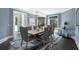 Sophisticated dining room with neutral tones, modern chandelier, and large windows at 330 Longvue Ct, Johns Creek, GA 30097