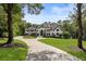 Beautiful home with circular driveway, lush landscaping, and mature trees at 330 Longvue Ct, Johns Creek, GA 30097
