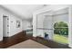 Second-floor hallway with glass railings and views of the stairway and backyard at 330 Longvue Ct, Johns Creek, GA 30097