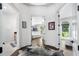 Bright hallway featuring hardwood floors, white walls, and views into a bathroom and walk-in closet at 330 Longvue Ct, Johns Creek, GA 30097