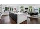 Open-concept kitchen featuring a large island with a marble countertop and hardwood floors leading to living area at 330 Longvue Ct, Johns Creek, GA 30097