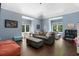 Comfortable living room featuring hardwood floors, a vaulted ceiling, large windows, and cozy furniture at 330 Longvue Ct, Johns Creek, GA 30097