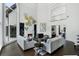 Living room with a fireplace, tall windows, high ceilings, and a view of a mezzanine level creating an airy atmosphere at 330 Longvue Ct, Johns Creek, GA 30097