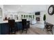 Open-concept living space with a kitchen island, a dining area, and a cozy living room with a fireplace at 330 Longvue Ct, Johns Creek, GA 30097