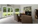 Bright home office with large windows, comfortable seating, and green backyard views at 330 Longvue Ct, Johns Creek, GA 30097