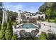 Stunning pool area with lush landscaping, lounge chairs, and manicured lawn; an oasis for relaxation at 330 Longvue Ct, Johns Creek, GA 30097