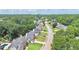 An aerial view showcasing a neighborhood with lush greenery and well-maintained homes at 445 Sweet Ivy Ln, Lawrenceville, GA 30043