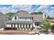 Back exterior view of home with patio and lush landscaping at 445 Sweet Ivy Ln, Lawrenceville, GA 30043