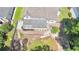 Aerial view of backyard featuring patio area, hardscape path, and mature trees at 445 Sweet Ivy Ln, Lawrenceville, GA 30043
