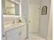 Modern bathroom features white cabinets, marble countertops, and a bright mirror at 445 Sweet Ivy Ln, Lawrenceville, GA 30043