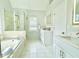 Bathroom with double vanity, glass shower and stand alone tub at 445 Sweet Ivy Ln, Lawrenceville, GA 30043