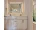 Modern bathroom with double vanity featuring quartz countertops, white cabinetry, and an LED mirror at 445 Sweet Ivy Ln, Lawrenceville, GA 30043