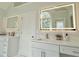 Modern bathroom with dual vanities, and bright mirrors at 445 Sweet Ivy Ln, Lawrenceville, GA 30043
