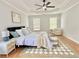 Comfortable bedroom features a tray ceiling, two windows and a ceiling fan at 445 Sweet Ivy Ln, Lawrenceville, GA 30043
