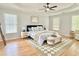Comfortable bedroom features a tray ceiling, two windows and a ceiling fan at 445 Sweet Ivy Ln, Lawrenceville, GA 30043
