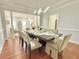 Dining room showing open floor plan, hardwood flooring, and modern light fixture at 445 Sweet Ivy Ln, Lawrenceville, GA 30043