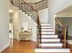 Interior shot of foyer with wood staircase and hardwood flooring at 445 Sweet Ivy Ln, Lawrenceville, GA 30043