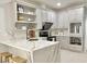 Modern kitchen with a marble waterfall island, stainless steel appliances, and stylish finishes at 445 Sweet Ivy Ln, Lawrenceville, GA 30043