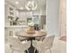 Eat-in kitchen area featuring a round table, decorative lighting, and tile flooring at 445 Sweet Ivy Ln, Lawrenceville, GA 30043