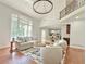 Spacious living room with tall windows, hardwood floors, and an open floor plan at 445 Sweet Ivy Ln, Lawrenceville, GA 30043