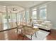 Bright living room with hardwood floors, large windows, stylish furniture, and neutral decor at 445 Sweet Ivy Ln, Lawrenceville, GA 30043