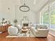 Bright living room features a fireplace, hardwood floors, and a large window at 445 Sweet Ivy Ln, Lawrenceville, GA 30043