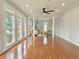 Open living room with hardwood floors, bright lighting, and a ceiling fan for added comfort at 445 Sweet Ivy Ln, Lawrenceville, GA 30043