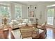 Cozy living room with hardwood floors, natural lighting, and stylish decor at 445 Sweet Ivy Ln, Lawrenceville, GA 30043