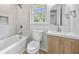 Bright bathroom featuring updated vanity, mirror, and shower over tub at 6402 Grafton Ct, Austell, GA 30168