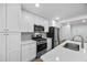 Bright kitchen boasts stainless appliances, white cabinetry, quartz counters, and a modern design at 6402 Grafton Ct, Austell, GA 30168