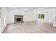 Inviting living room featuring a stone fireplace, large windows, and stylish flooring for a comfortable ambiance at 6402 Grafton Ct, Austell, GA 30168