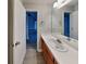 Bright bathroom featuring wood cabinets, neutral walls, large vanity and a view into the hallway at 115 Hugh Dr, Covington, GA 30016