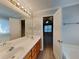 Main bathroom with double sinks, white countertops and cabinets and a view of main bedroom at 115 Hugh Dr, Covington, GA 30016