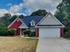 Charming single-Gathering home featuring a two-car garage, beautiful lawn and mature trees at 115 Hugh Dr, Covington, GA 30016