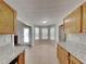 Kitchen with dining area featuring tile floors, granite counters, and white trim at 115 Hugh Dr, Covington, GA 30016