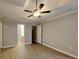 Spacious main bedroom features modern ceiling fan, tray ceiling, and updated floors at 115 Hugh Dr, Covington, GA 30016