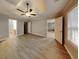 Main bedroom featuring a tray ceiling, modern ceiling fan, and bright windows at 115 Hugh Dr, Covington, GA 30016