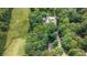 Aerial of treed parcel showing the natural surroundings close to a main house and its pool at 1526 Oakleaf Dr, Auburn, GA 30011