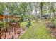 Backyard featuring a deck with seating, a lush lawn, and wooded surroundings at 1526 Oakleaf Dr, Auburn, GA 30011