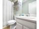 Cozy bathroom features a shower-tub combo with a white shower curtain and white vanity with storage at 1526 Oakleaf Dr, Auburn, GA 30011